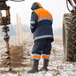 Acme Fence Drilling Fence Post with Auger in Northeast Ohio Cold Weather Snow
