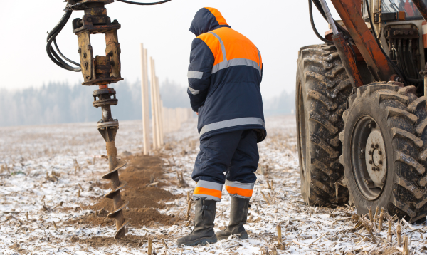 Acme Fence Drilling Fence Post with Auger in Northeast Ohio Cold Weather Snow